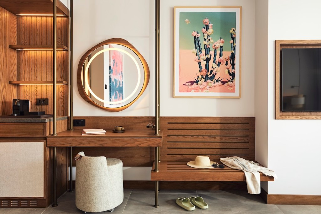 Wooden vanity with circular mirror, cream stool, wooden bench